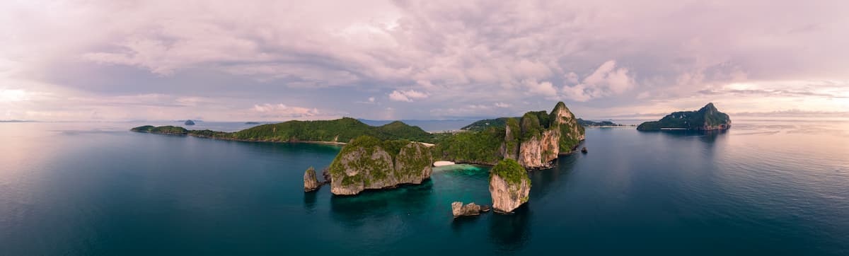 Aerial panorama of the Phi Phi islands with limestone cliffs and emerald sea at dawn, perfect opener for a Phi Phi and Khai Islands day tour from Phuket