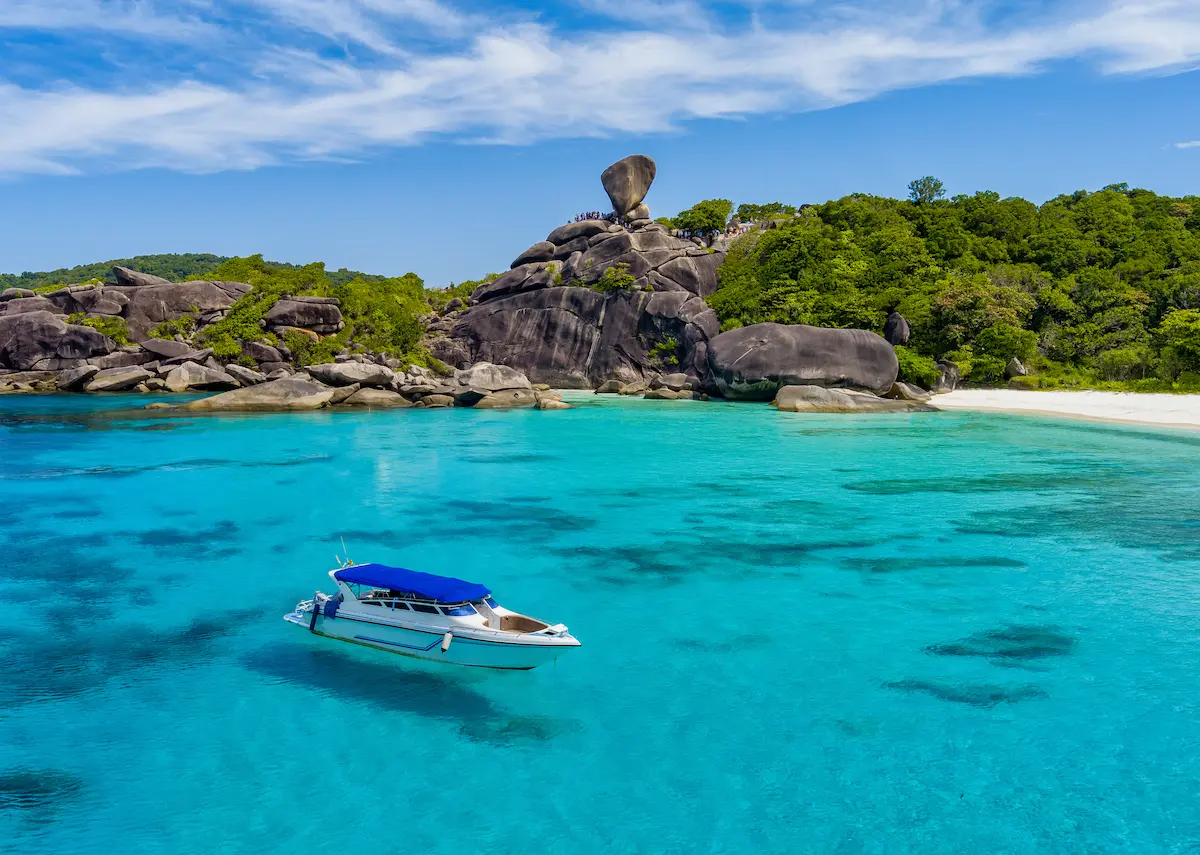 Speedboat anchored near Sail Rock viewpoint on Koh Similan in the Similan Islands, Thailand, surrounded by turquoise water and granite cliffs