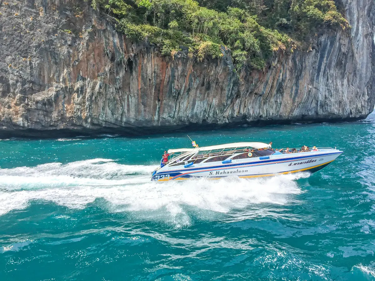 Speedboat to the Similan Islands slicing across turquoise water near Khao Lak’s limestone cliffs