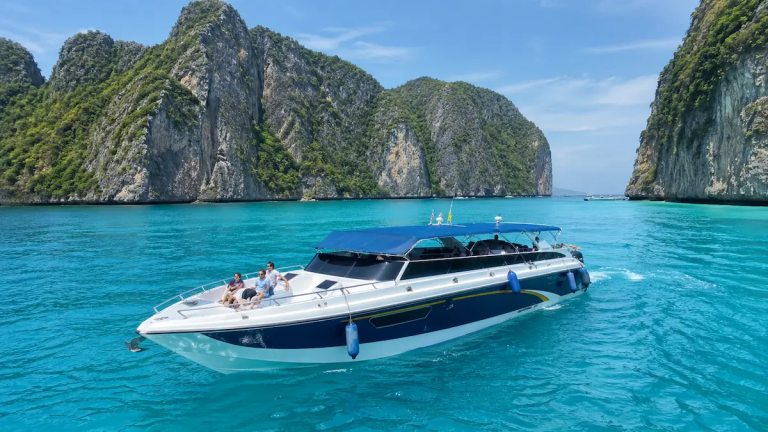 Best Phi Phi Island tour from Phuket speedboat near Phi Phi Islands with limestone cliffs and clear blue water