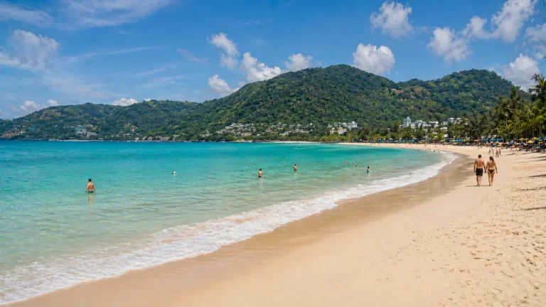 Patong Beach Phuket wide bay with turquoise water sandy shoreline and natural beach activity