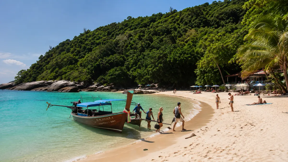 Travellers arriving by longtail boat at Freedom Beach Phuket