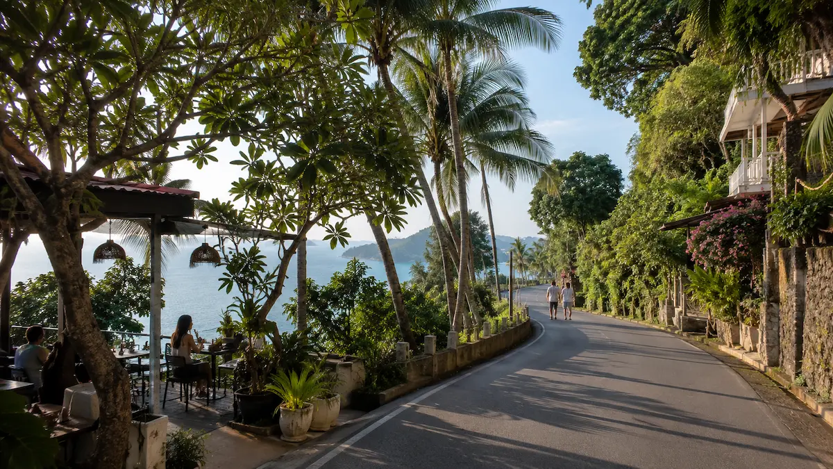 Quiet coastal road with tropical hillside scenery in Cape Panwa Phuket