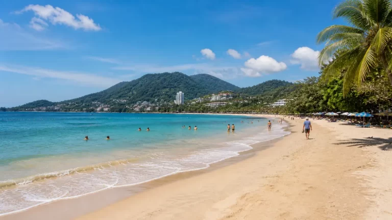 Phuket beach scene with tourists swimming and walking showing a safe and relaxed travel environment