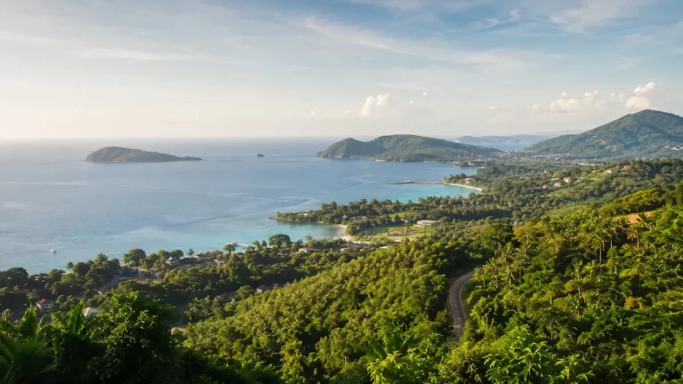 Scenic coastal view of South Phuket with green hills, quiet bays, blue water and tropical coastline near Rawai, Nai Harn, Chalong and Cape Panwa.