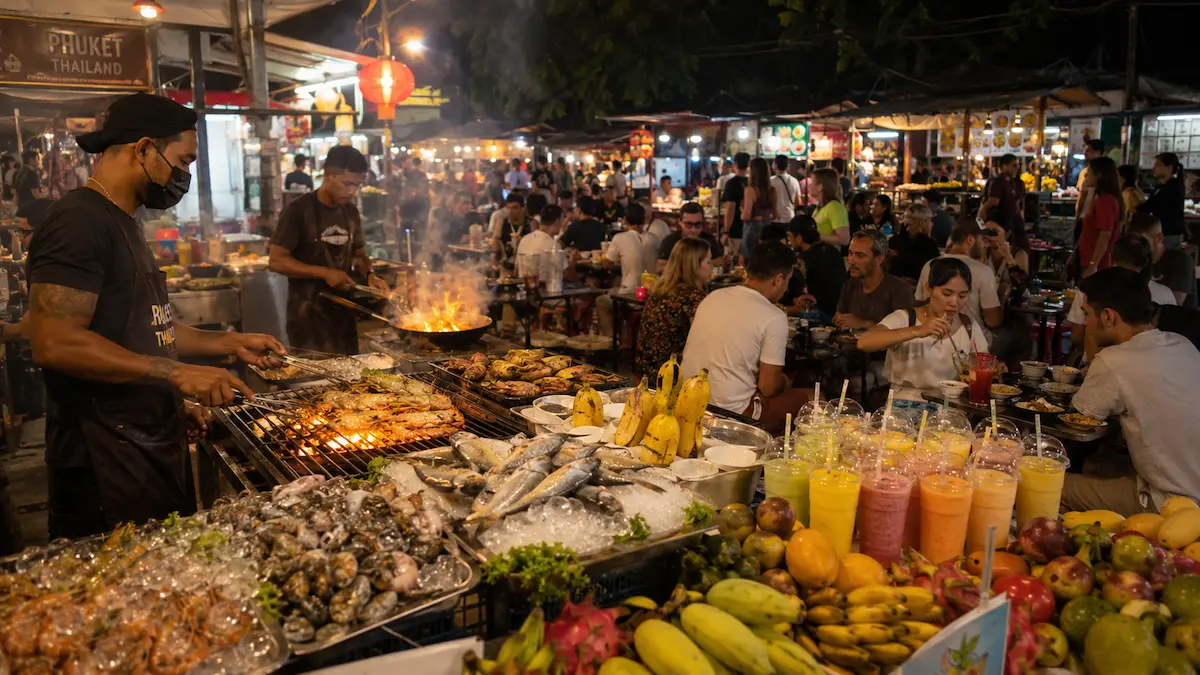 Thai street food and grilled seafood at a busy Phuket night market in Thailand