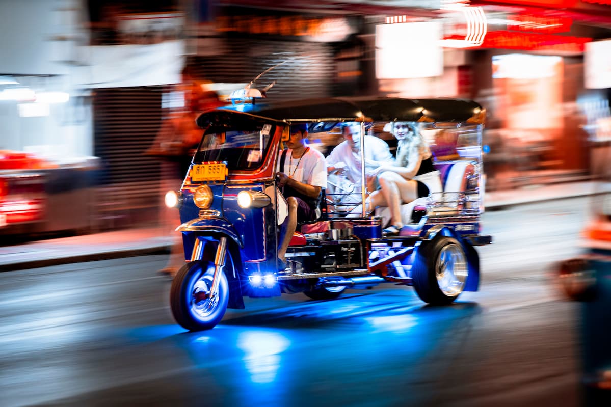 Explore Thailand – tuk-tuk travelling through the streets of Bangkok at night